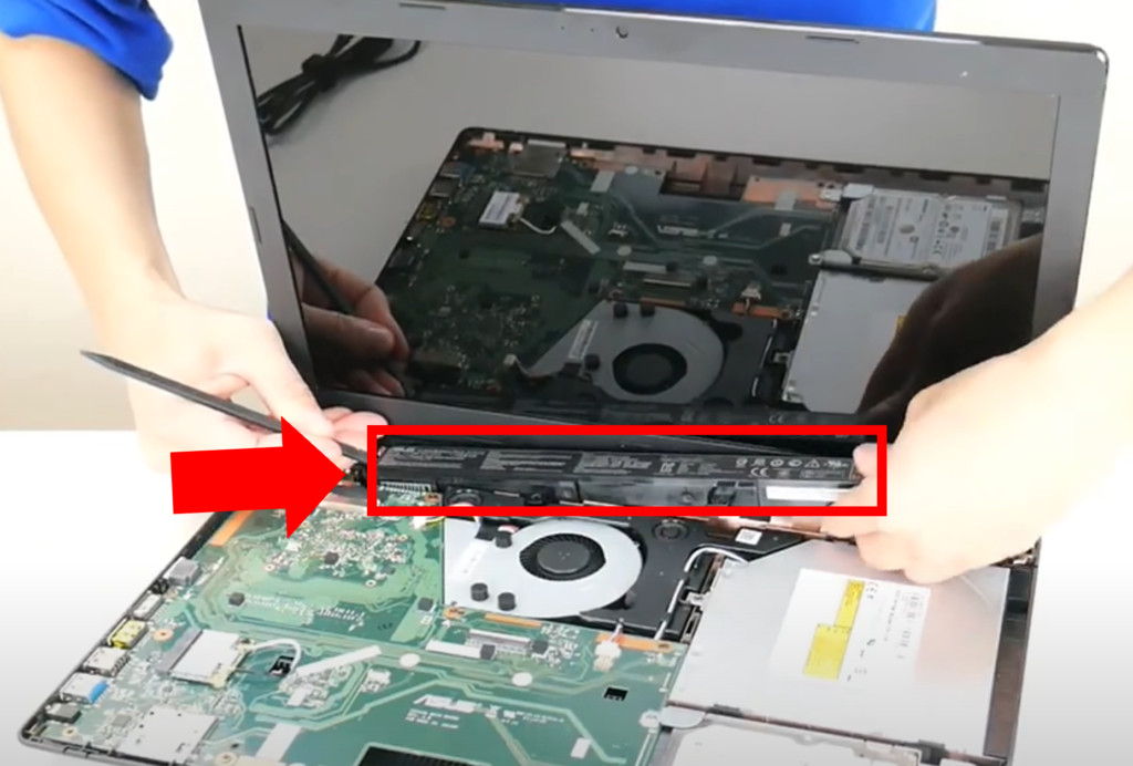 Internal laptop battery being removed.