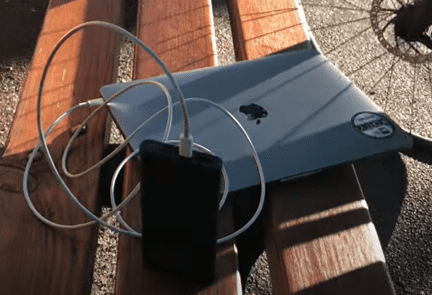 Portable power bank charging a Macbook